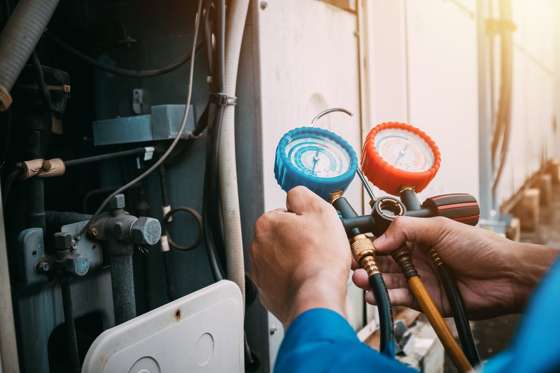 HVAC technician servicing air conditioning unit